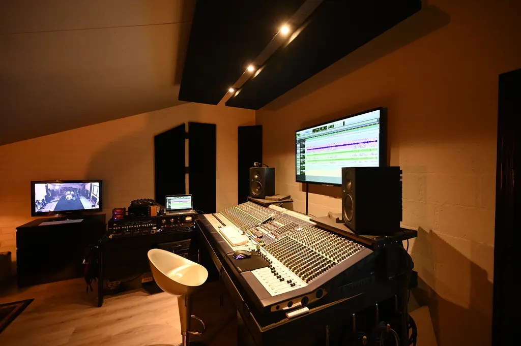 Control room at Dennis Geraads Studio with large Soundcraft mixing console, studio monitors and DAW screen