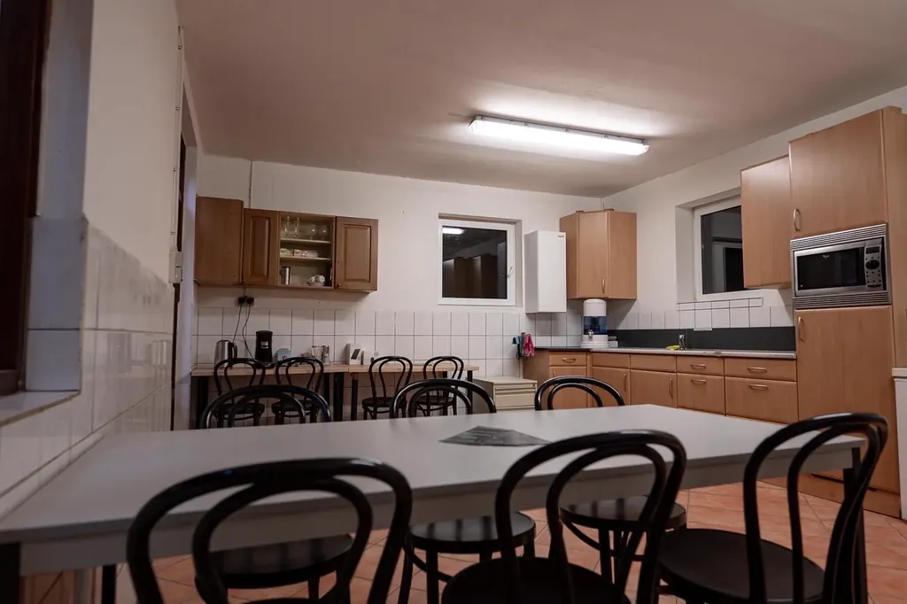 Spacious studio lounge with coffee bar, fridge, microwave and large table with seating